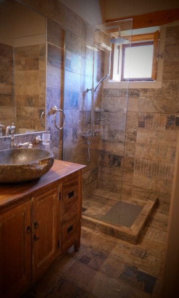 Tiled shower room with stone basin